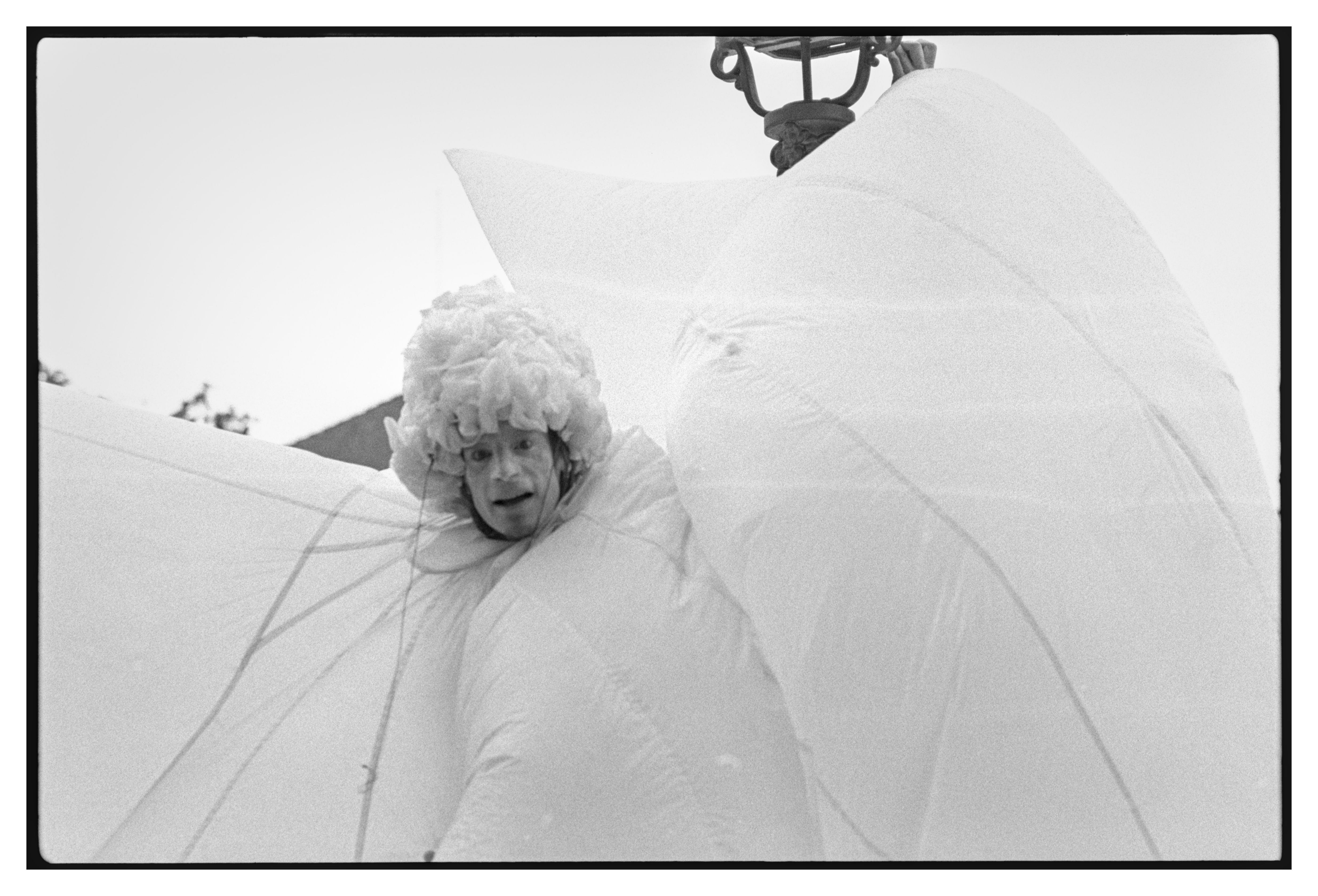 Black and white photograph in landscape orientation.
A close up of the final actor in their inflated costume.