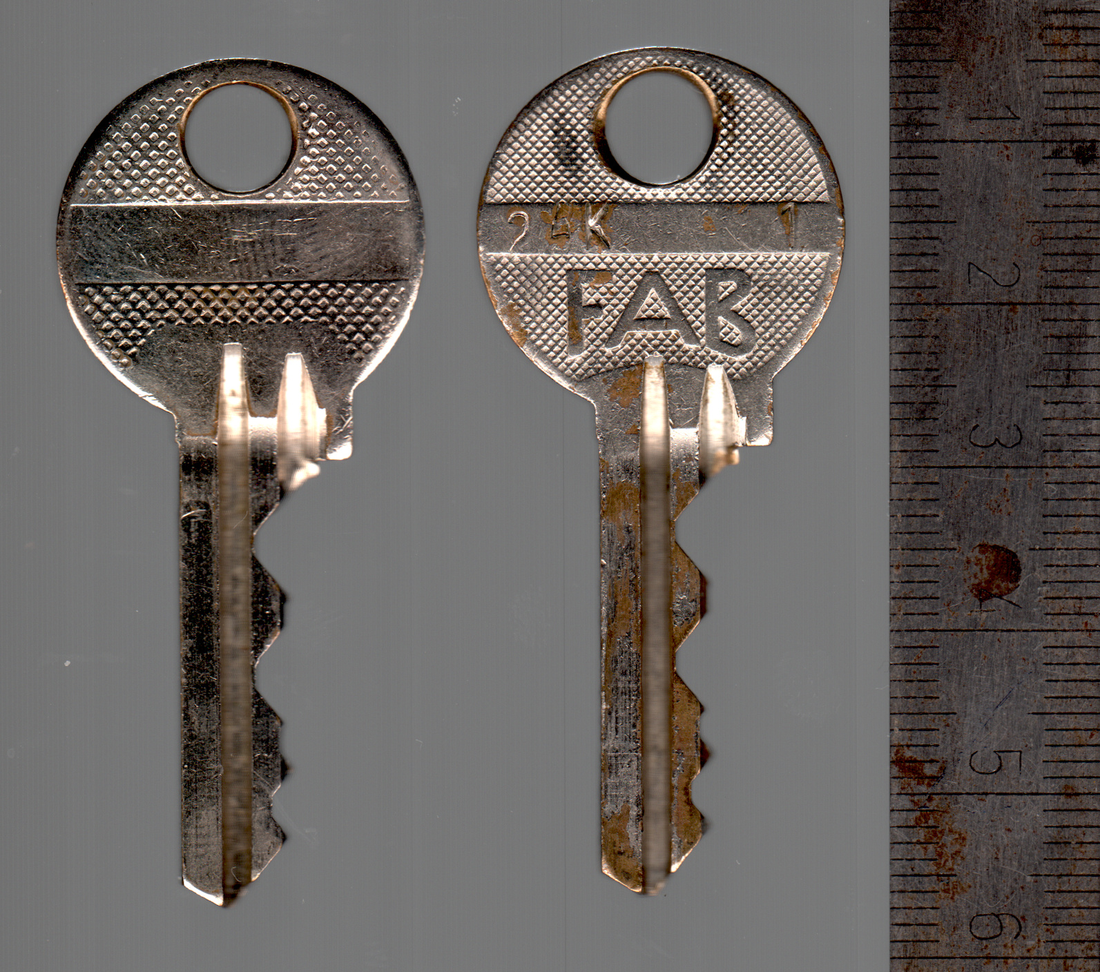 FAB 2018 keys, original on the right with The FAB marking, a plain modern copy on the left.