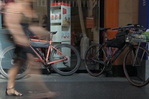 a person passes through two packed bikes inside a train station